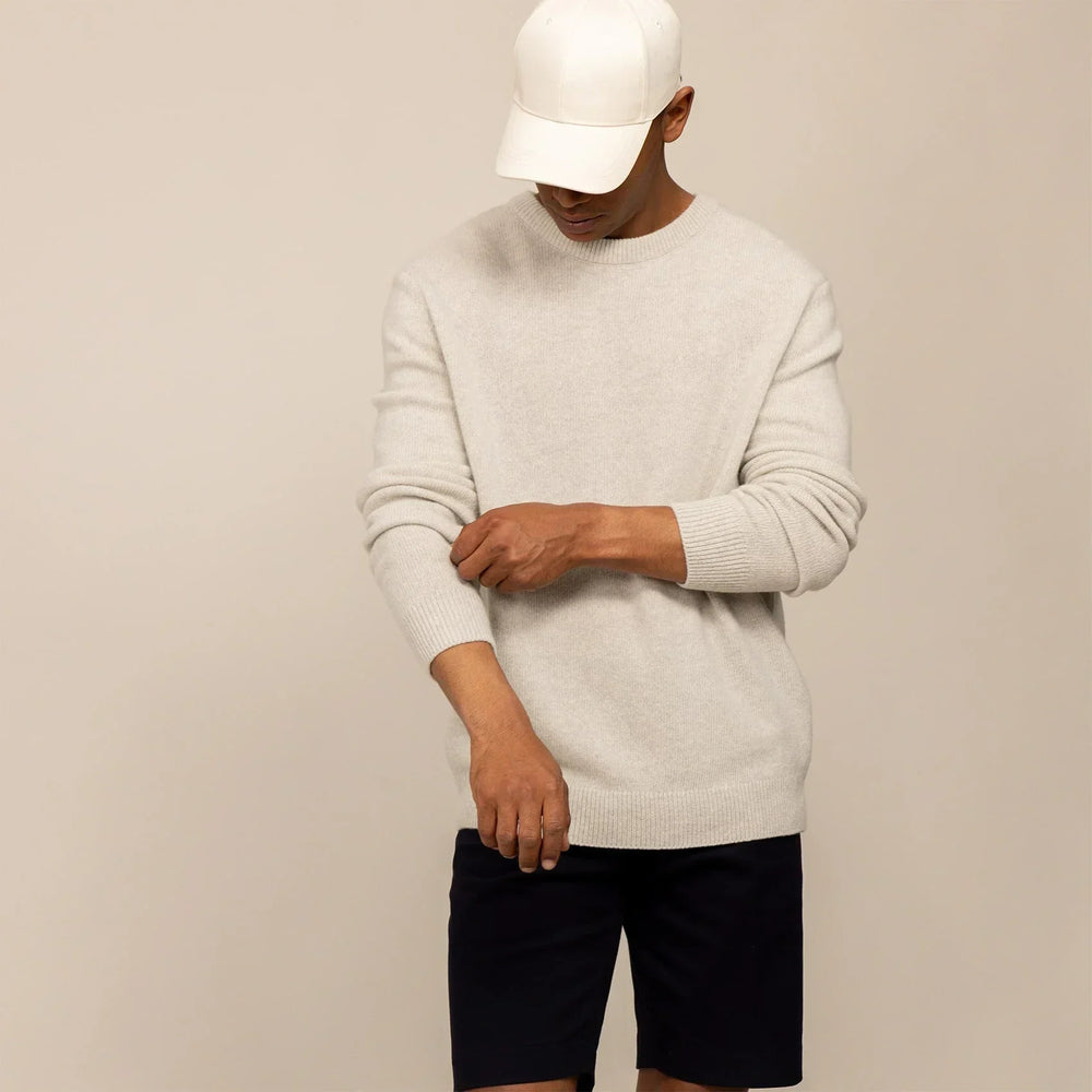 Man wearing a Merino Wool Crew Neck Knit Jumper in Speckled Grey, front view.
