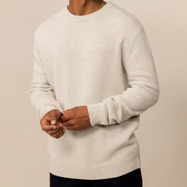 Man wearing a Marame Merino Wool Crew Neck Knit Jumper in Speckled Grey, front view.