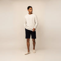 Man wearing a Marame Merino Wool Crew Neck Knit Jumper in Speckled Grey, front view.|speckled grey