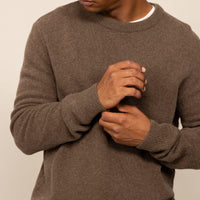 Man wearing a Marame Merino Wool Crew Neck Knit Jumper in wholemeal, closeup.
