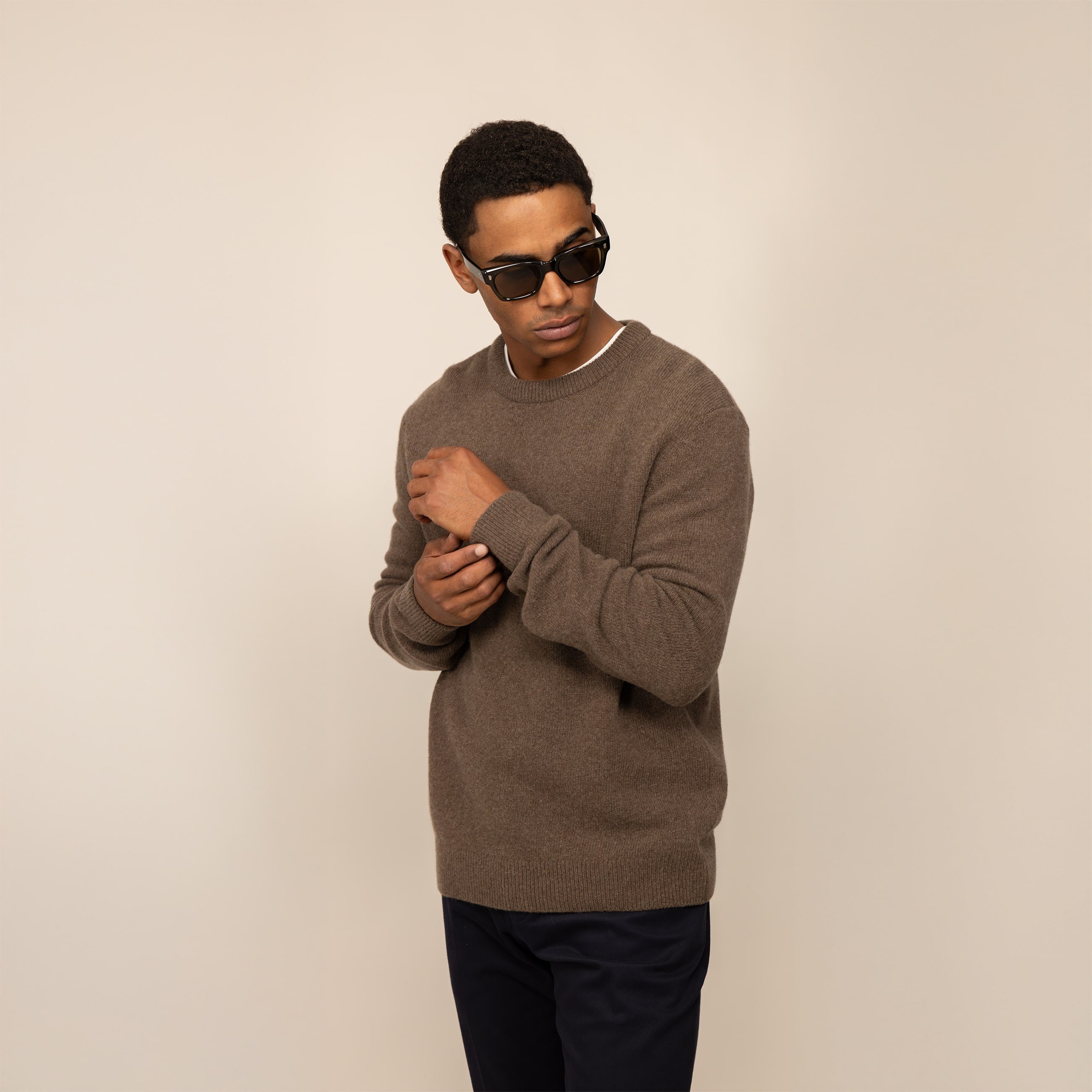Man wearing a Marame Merino Wool Crew Neck Knit Jumper in wholemeal, front view.