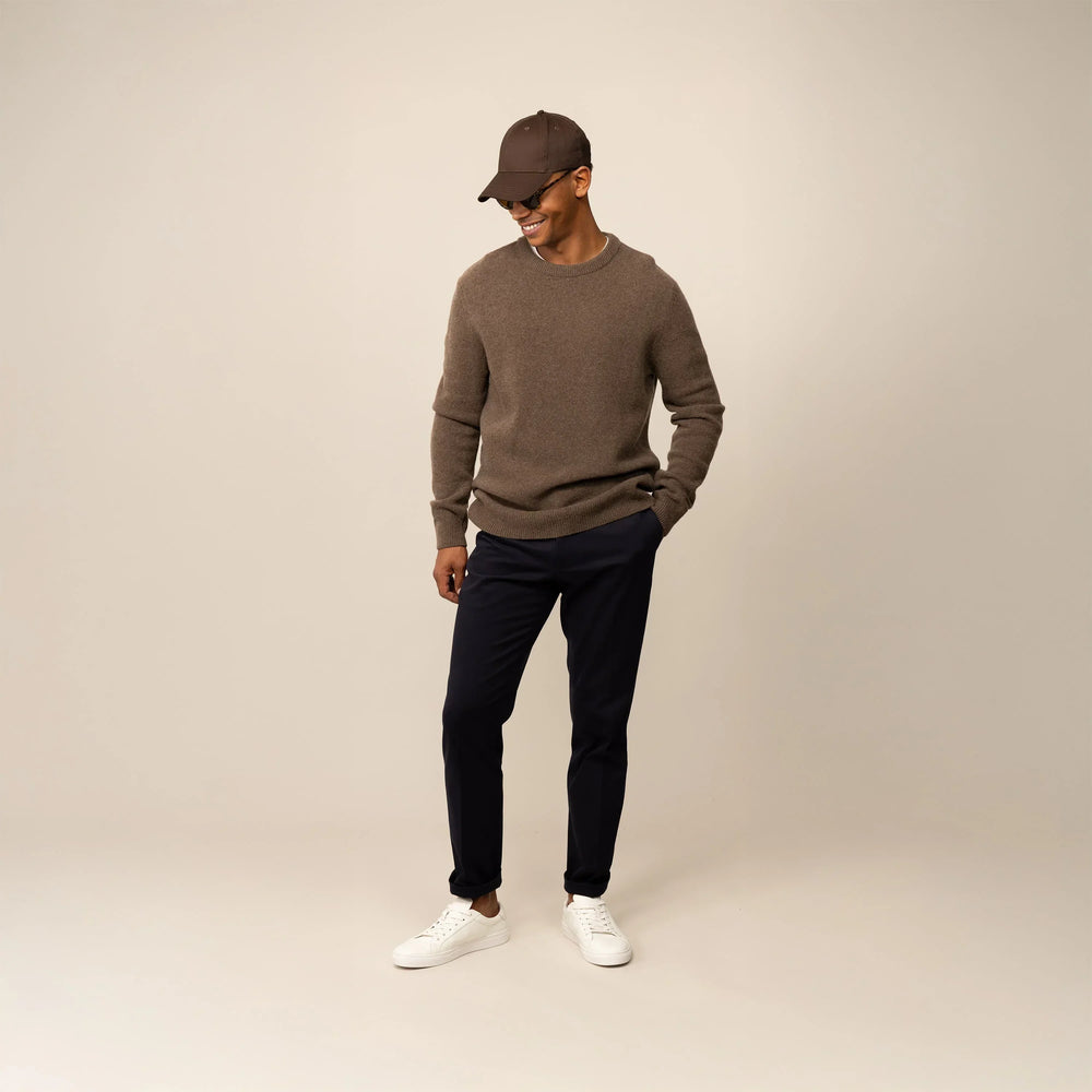 Man wearing a Marame Merino Wool Crew Neck Knit Jumper in wholemeal, front view.
