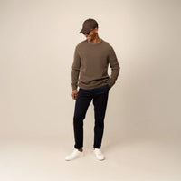 Man wearing a Marame Merino Wool Crew Neck Knit Jumper in wholemeal, front view.