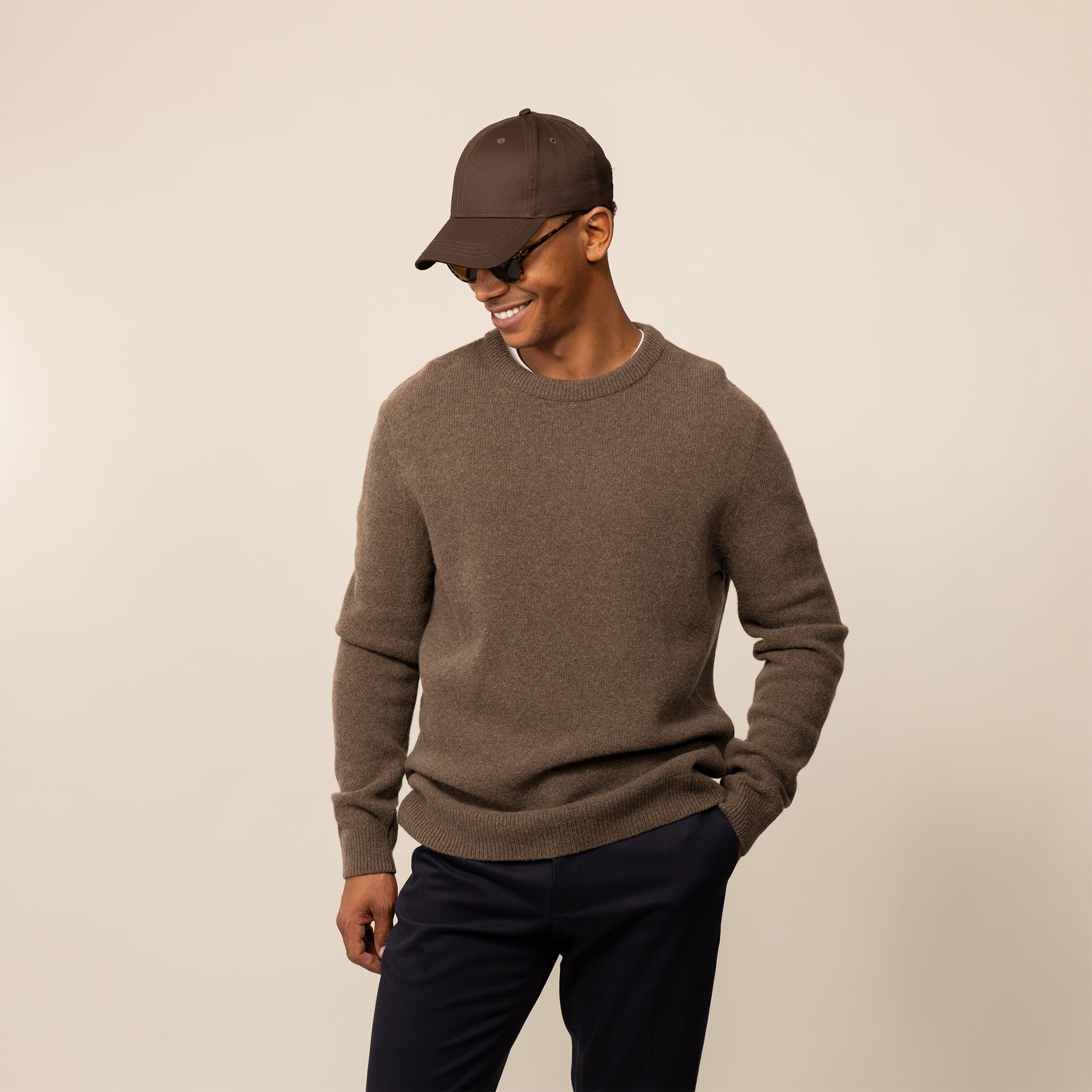 Man wearing a Marame Merino Wool Crew Neck Knit Jumper in wholemeal, front view.