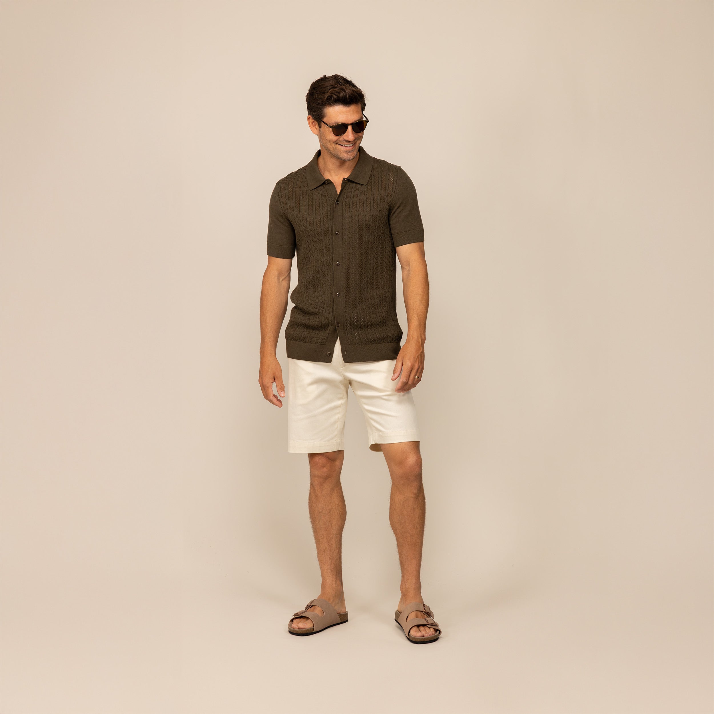Man wearing morning meadow cable knit short sleeve shirt, front view.