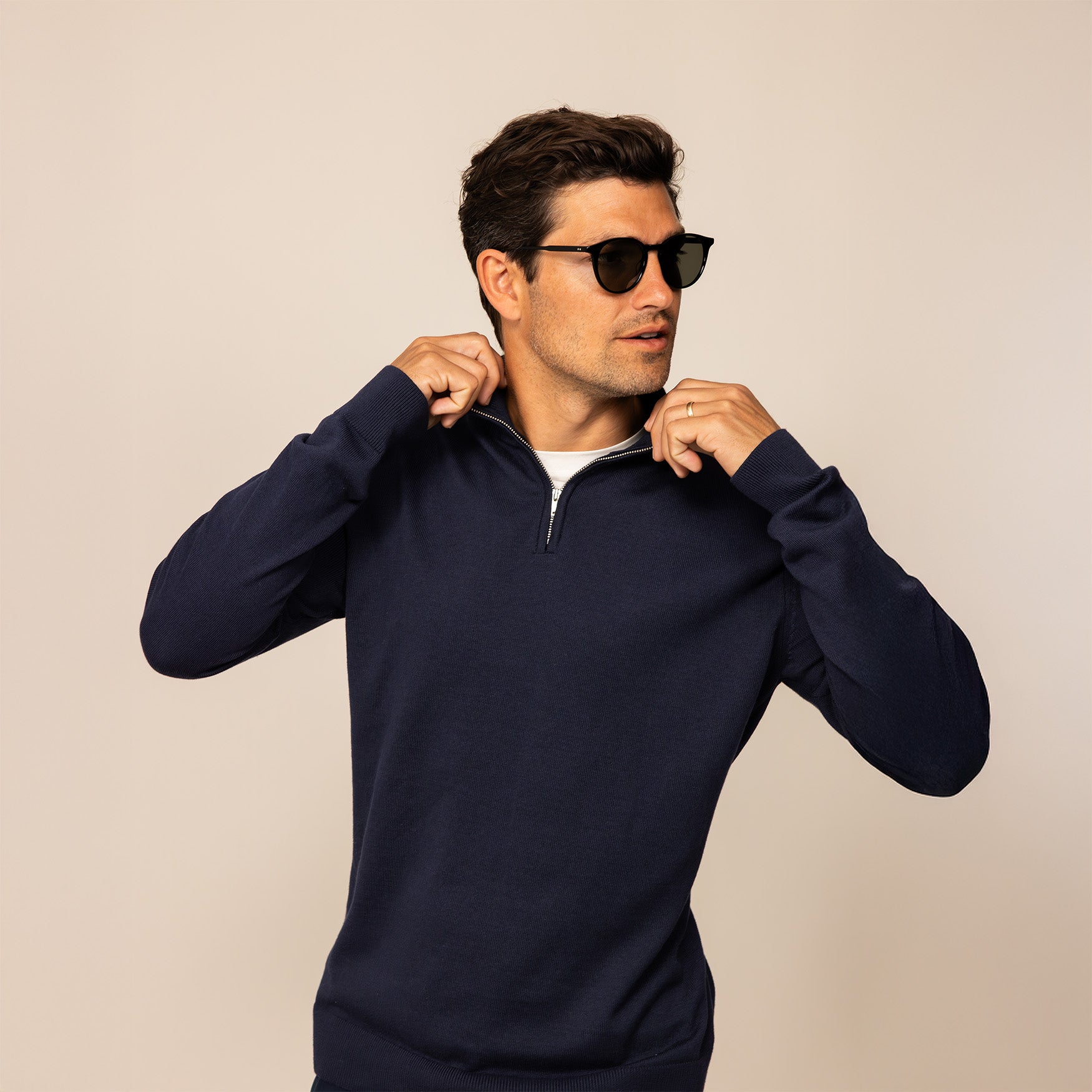 Man wearing a navy half zip jumper, front view.