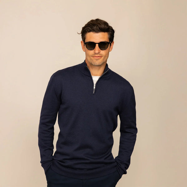 Man wearing a navy half zip jumper, front view.