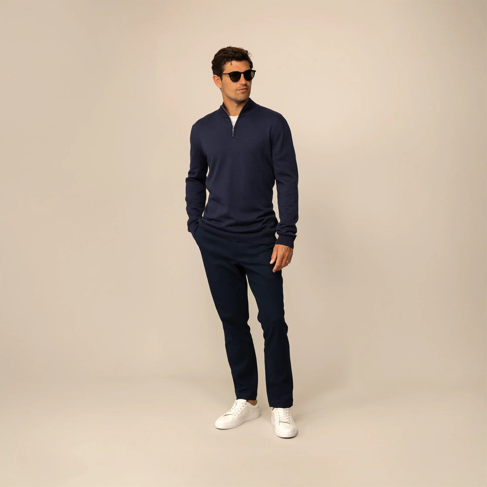 Man wearing a navy half zip jumper, front view.