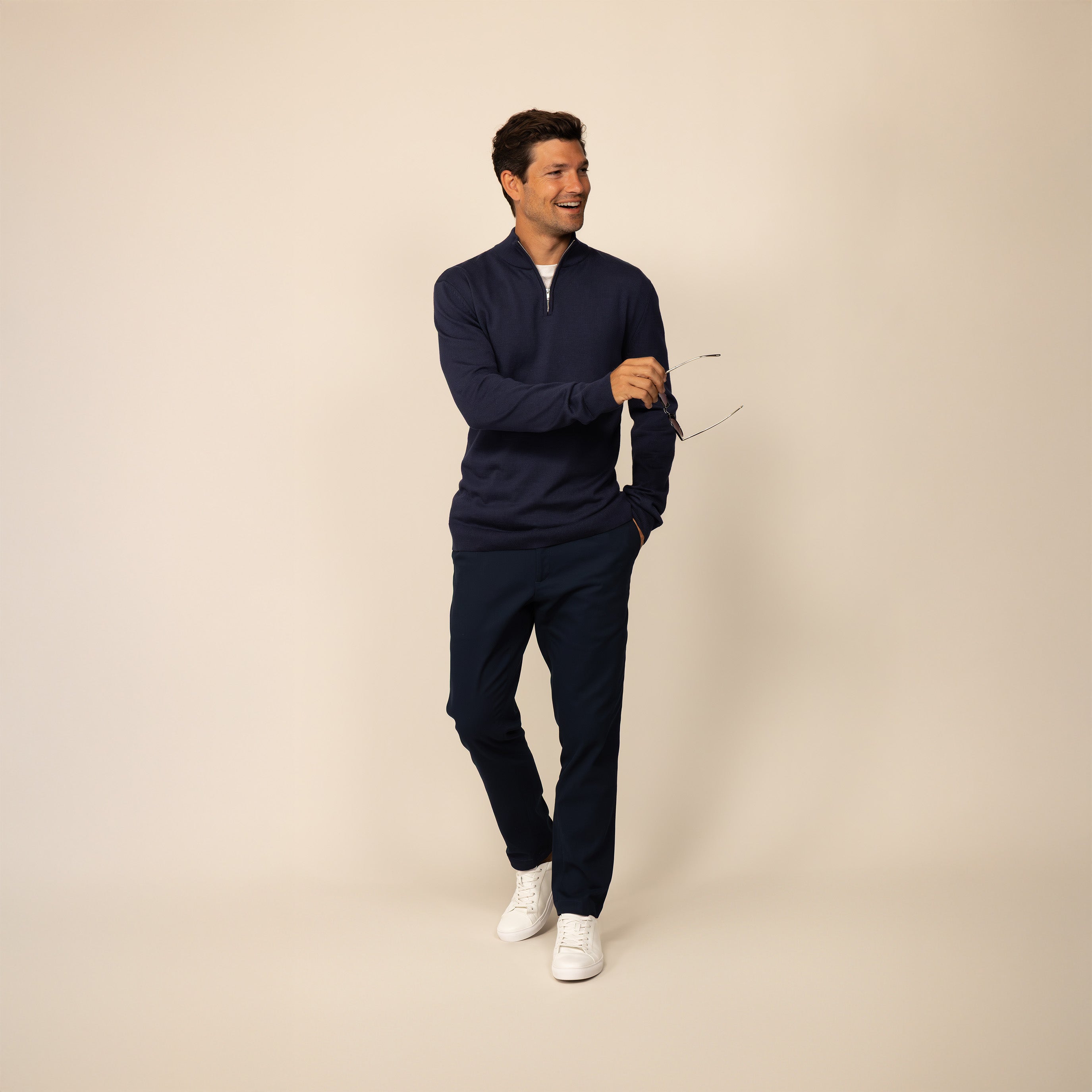 Man wearing a navy half zip jumper, front view.