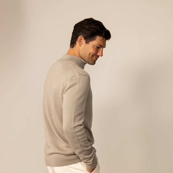 Man wearing a putty dove half zip jumper, rear view.