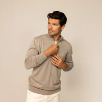 Man wearing a putty dove half zip jumper, front view. |putty dove
