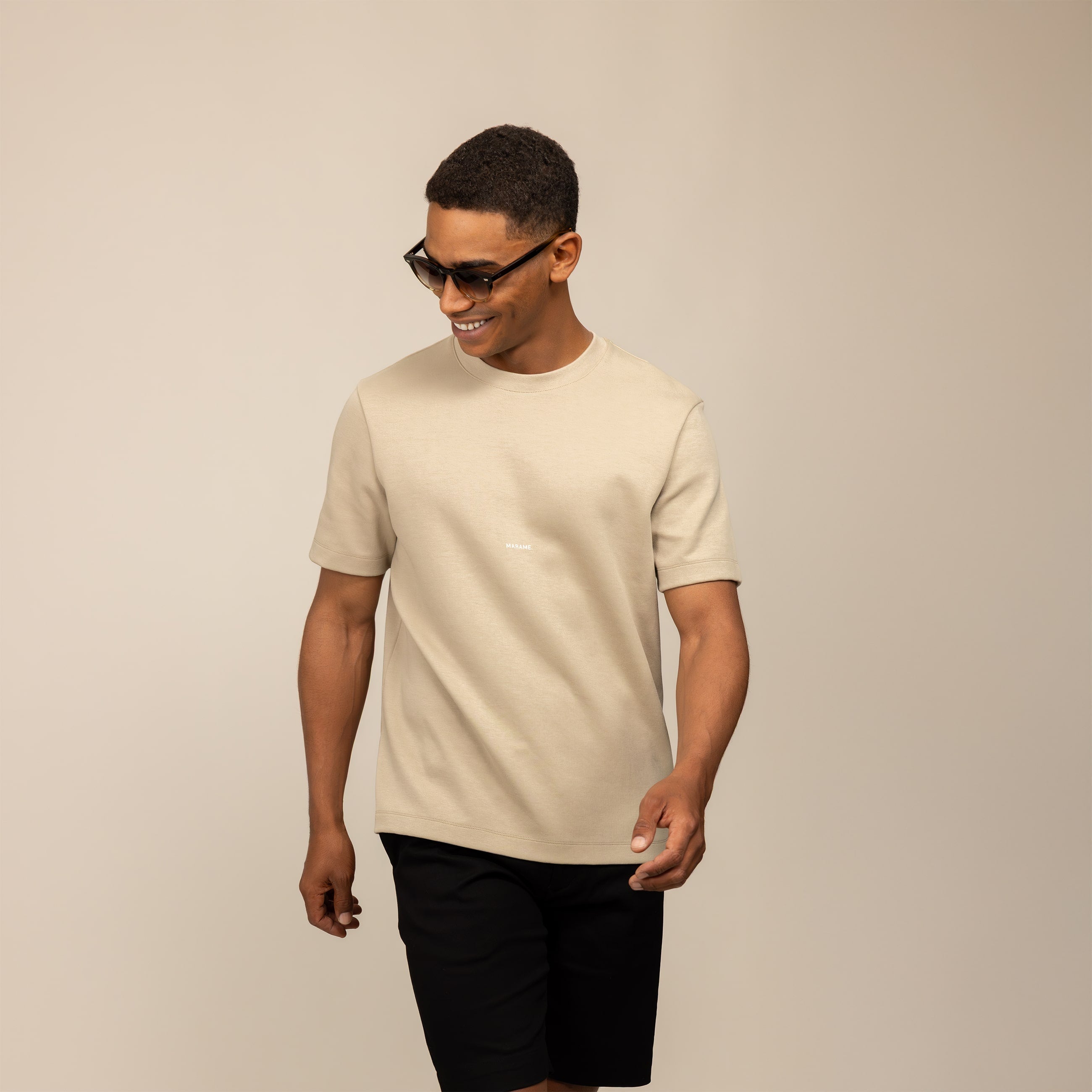 Man wearing a Marame Relaxed Fit Logo T-Shirt in Canyon Clay, front view.