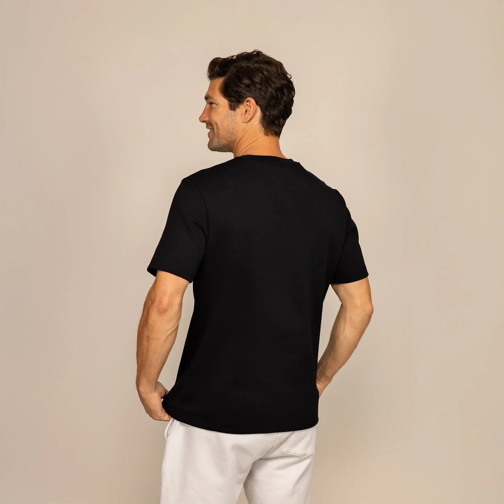 Man wearing a Marame Relaxed Fit T-Shirt in Black, rear view.