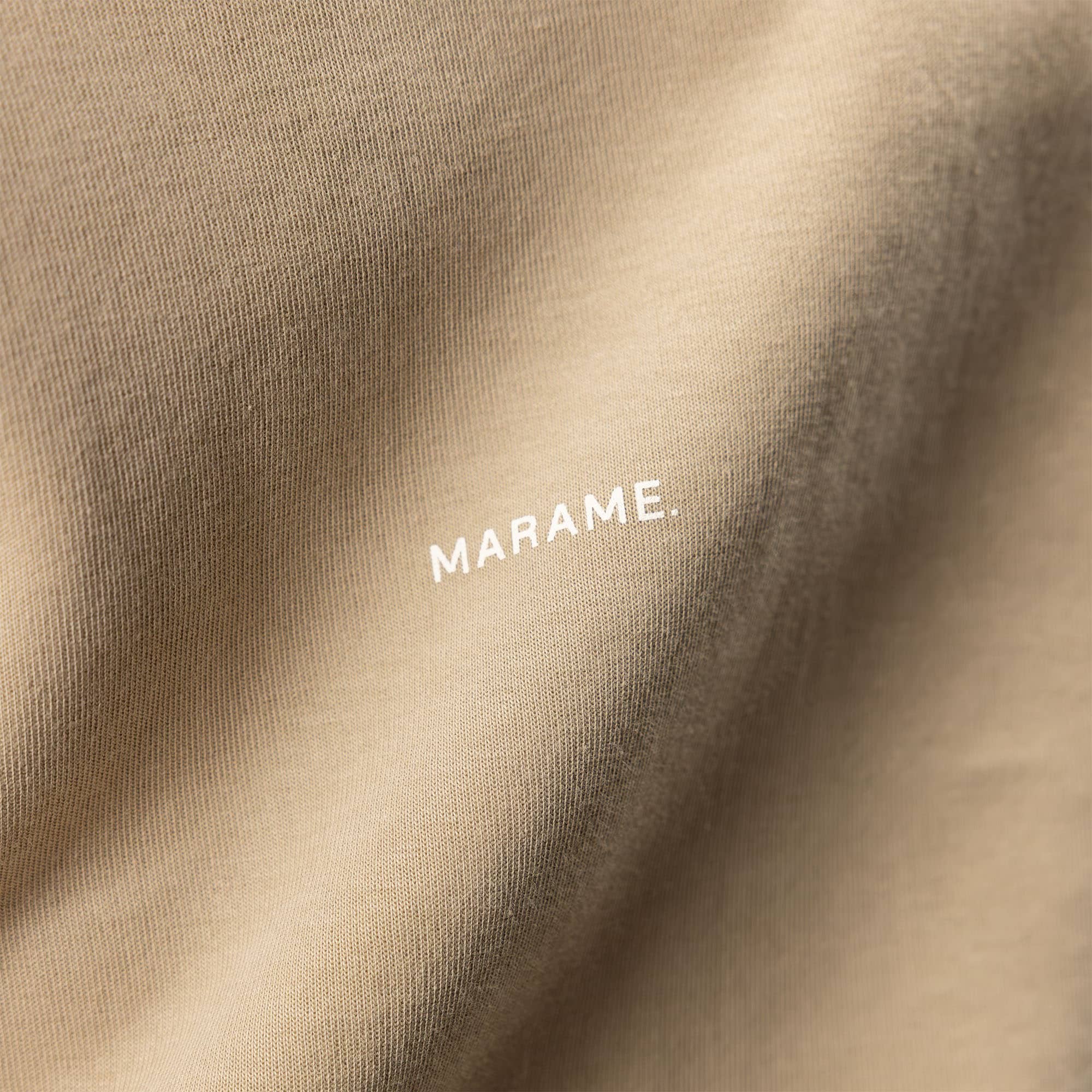 Man wearing a Marame Relaxed Fit T-Shirt in Canyon Clay, closeup.