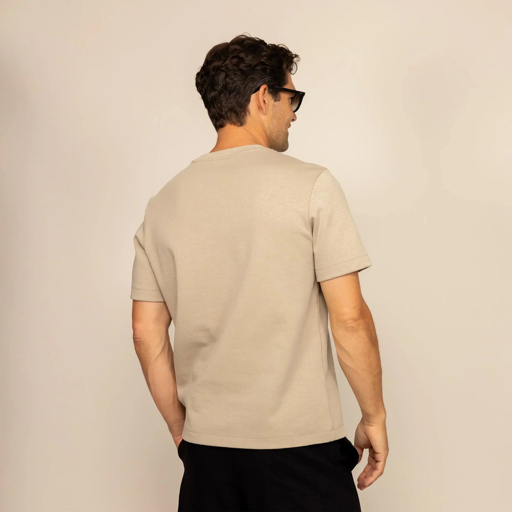 Man wearing a Marame Relaxed Fit T-Shirt in Canyon Clay, rear view.