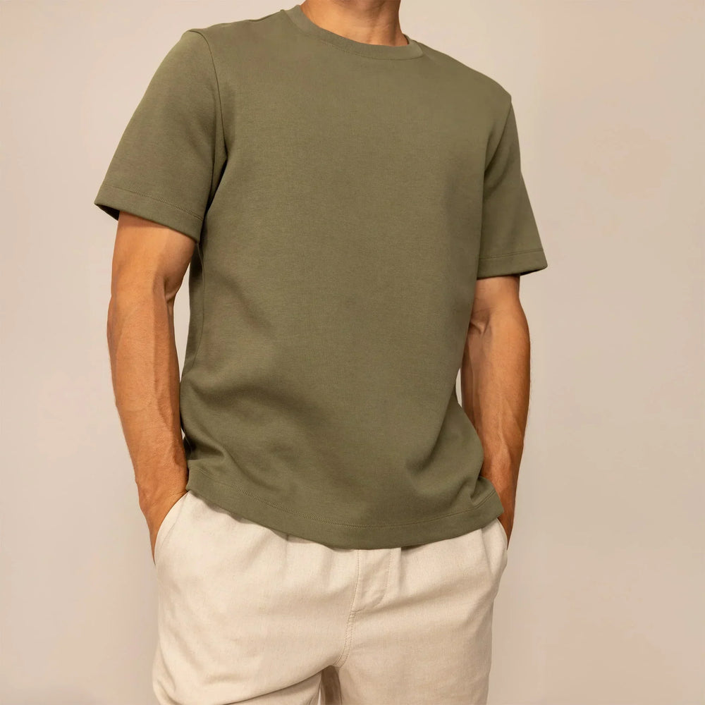 Man wearing a Marame Relaxed Fit T-Shirt in Olive, front view.