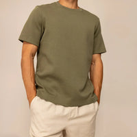 Man wearing a Marame Relaxed Fit T-Shirt in Olive, front view.