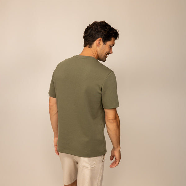 Man wearing a Marame Relaxed Fit T-Shirt in Olive, rear view.