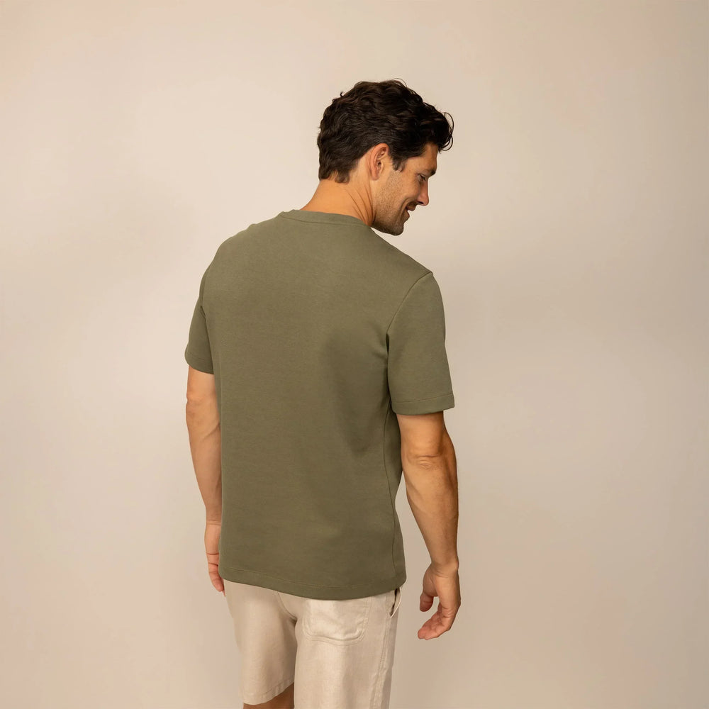 Man wearing a Marame Relaxed Fit T-Shirt in Olive, rear view.