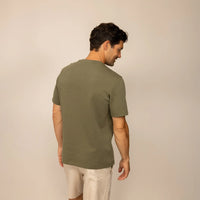 Man wearing a Marame Relaxed Fit T-Shirt in Olive, rear view.