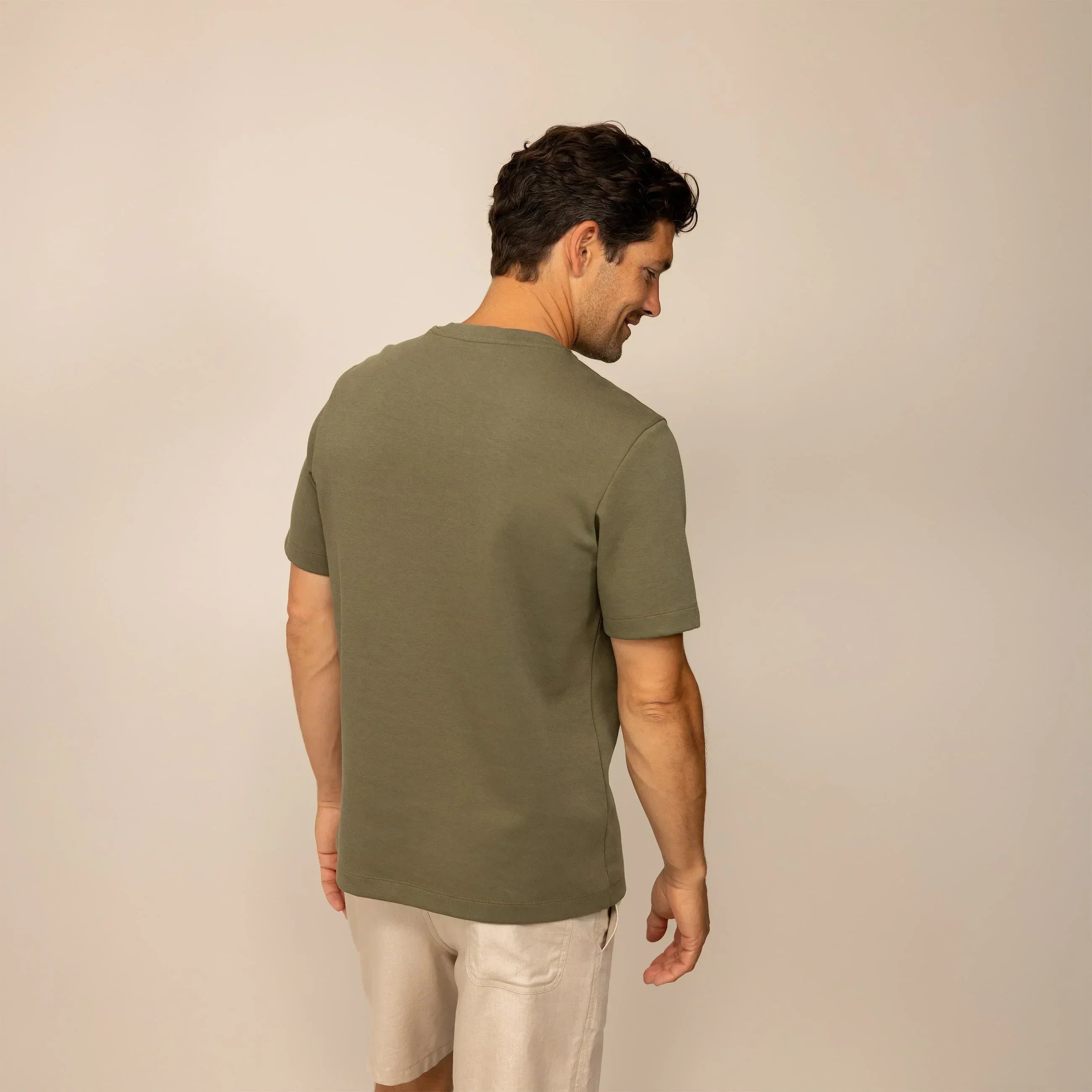Man wearing a Marame Relaxed Fit T-Shirt in Olive, rear view. |olive