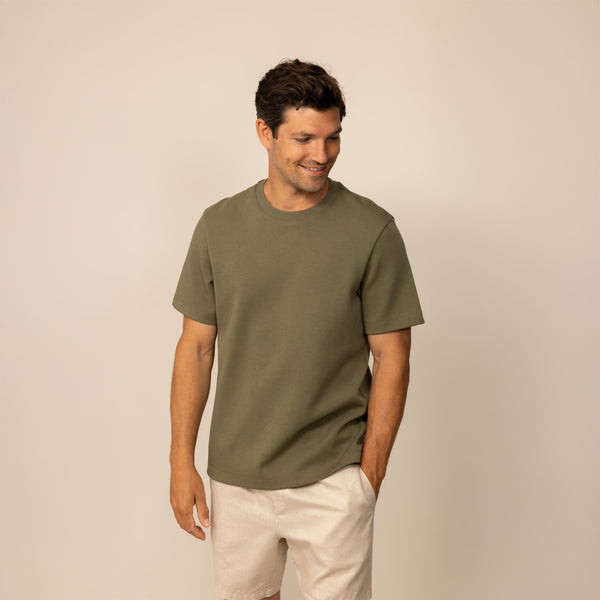 Man wearing a Marame Relaxed Fit T-Shirt in Olive, front view.