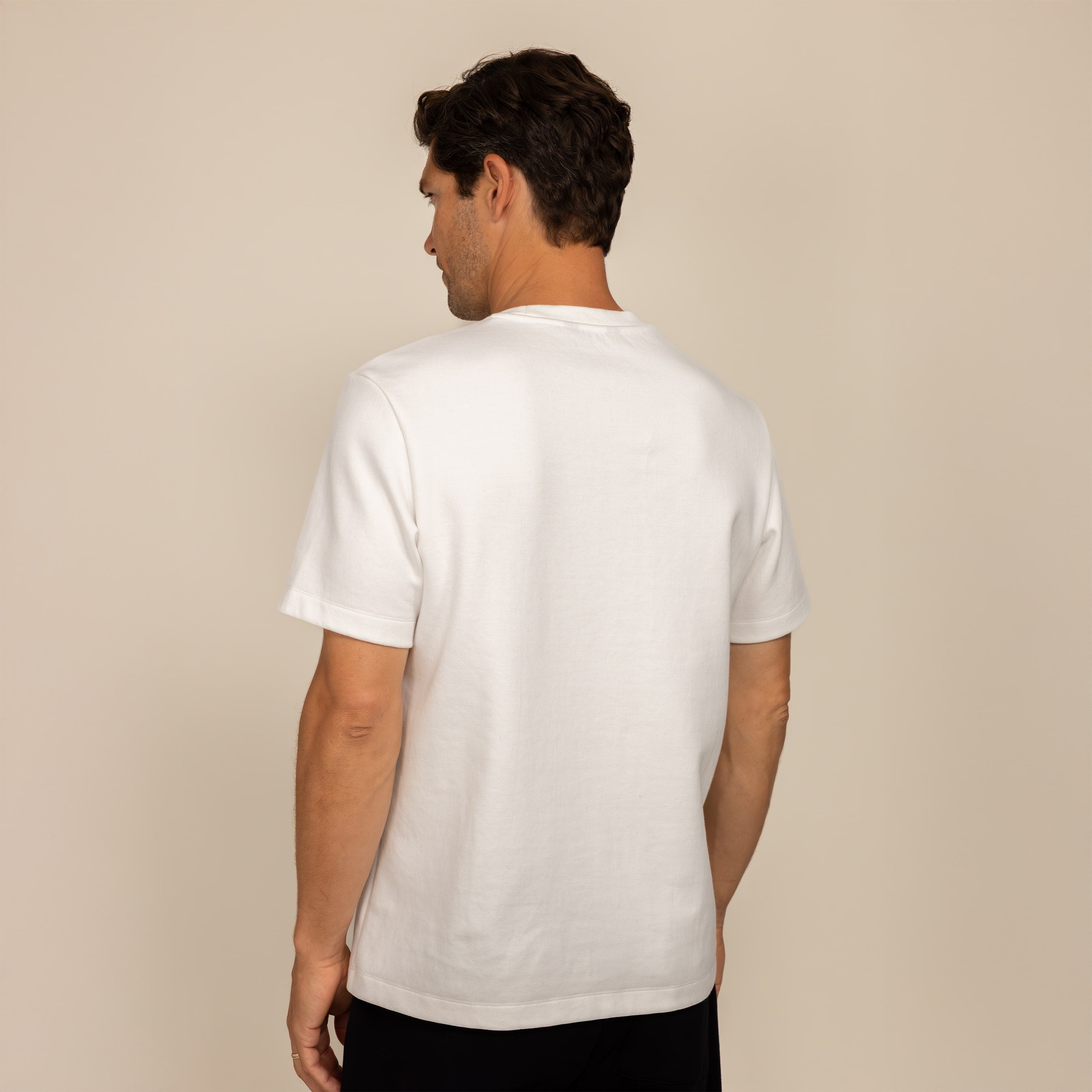 Man wearing a Marame Relaxed Fit T-Shirt in White, rear view.