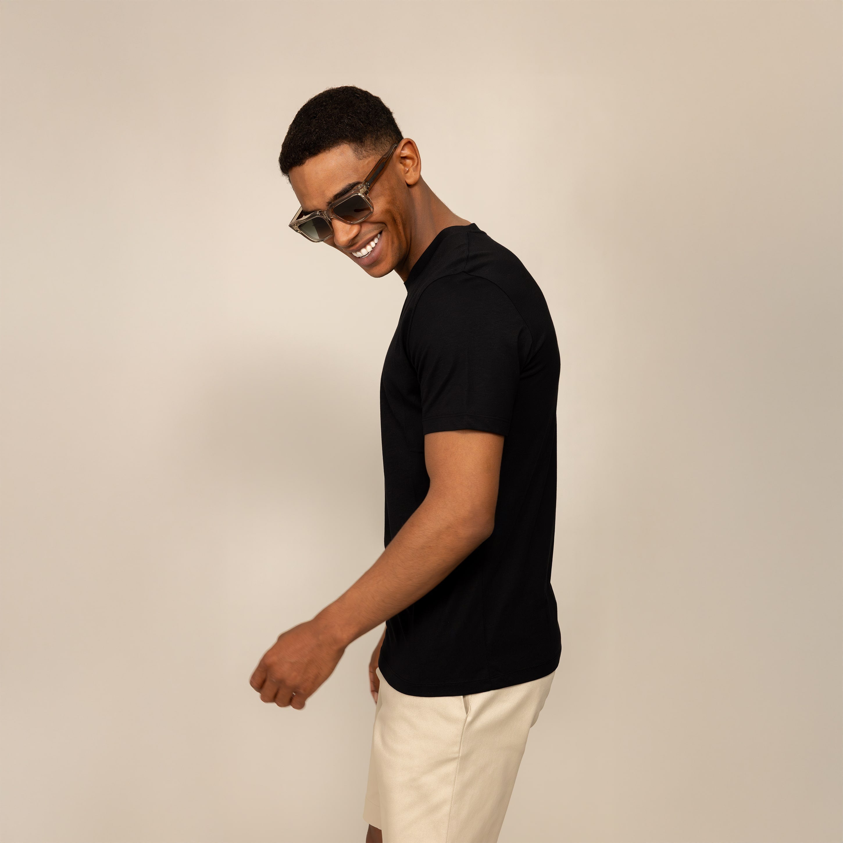 Man wearing a Marame Slim Fit Lyocell Blend T-Shirt in Black, side view.
