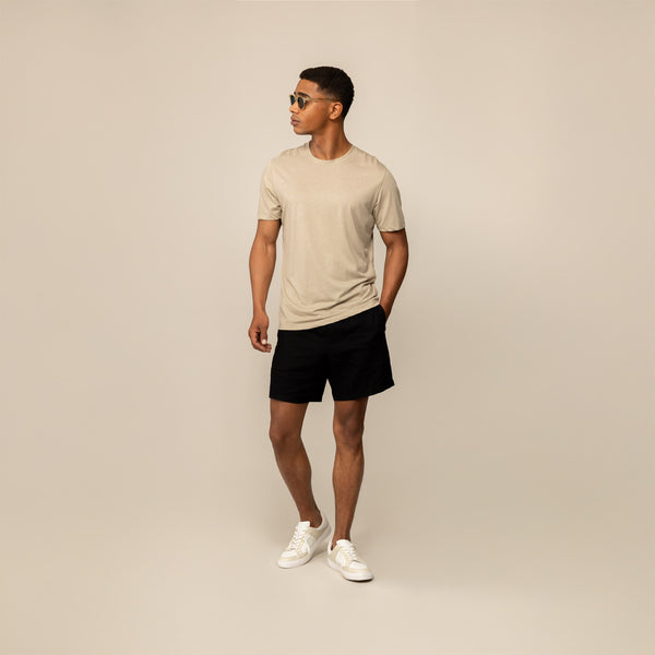 Man wearing a Marame Slim Fit Lyocell Blend T-Shirt in Canyon Clay, front view.