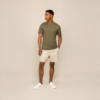 Man wearing a Marame Slim Fit Lyocell Blend T-Shirt in Olive, front view.