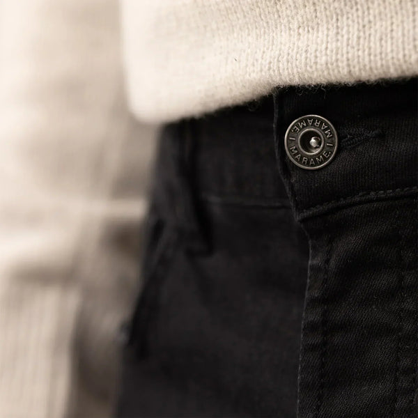 Man wearing Marame Slim Leg Denim Jeans in Black, closeup. |black denim