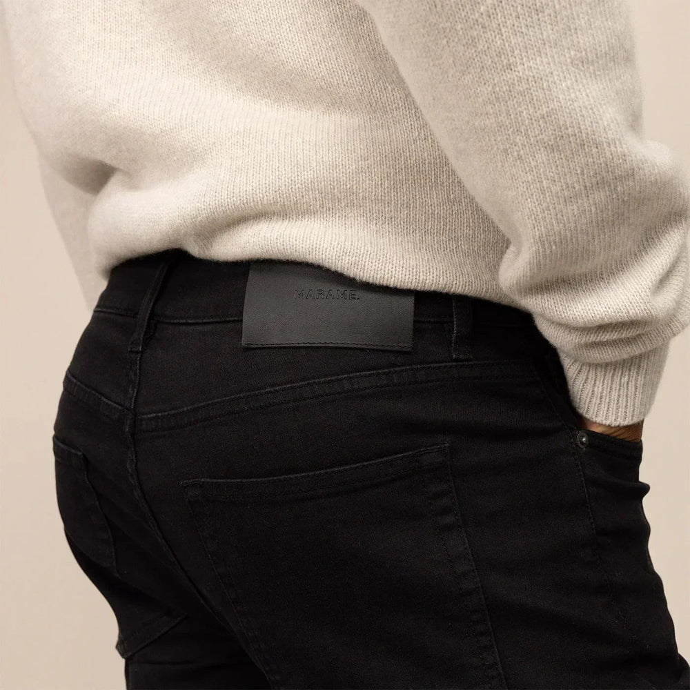 Man wearing Slim Leg Denim Jeans in Black, closeup. |black denim