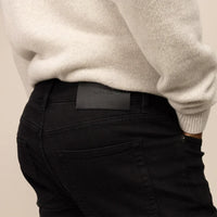 Man wearing Slim Leg Denim Jeans in Black, closeup. |black denim