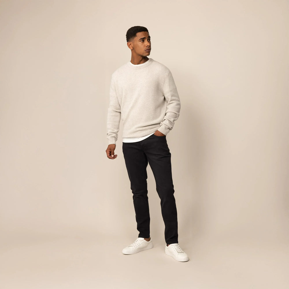 Man wearing Marame Slim Leg Denim Jeans in Black, front view.