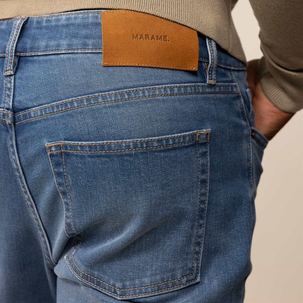 Man wearing Slim Leg Denim Jeans in Classic Wash, closeup. |classic wash denim