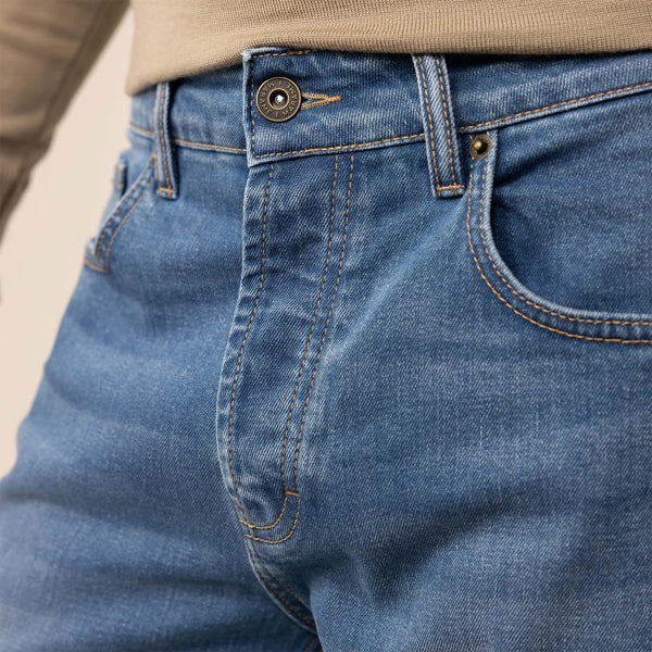Man wearing Marame Slim Leg Denim Jeans in Classic Wash, closeup. |classic wash denim