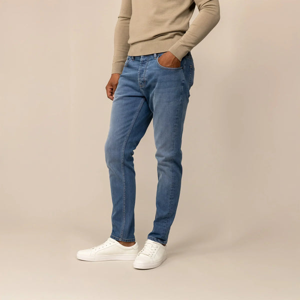 Man wearing Marame Slim Leg Denim Jeans in Classic Wash, front view.