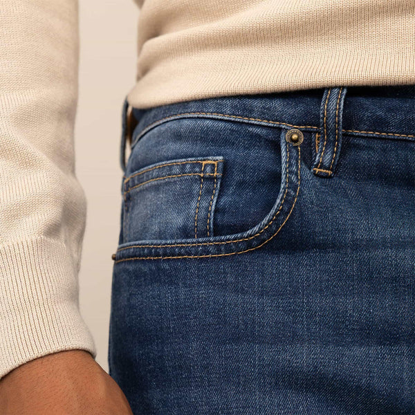 Man wearing Slim Leg Denim Jeans in Deep Navy, closeup. |navy wash denim