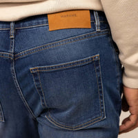 Man wearing Slim Leg Denim Jeans in Deep Navy, closeup. |navy wash denim