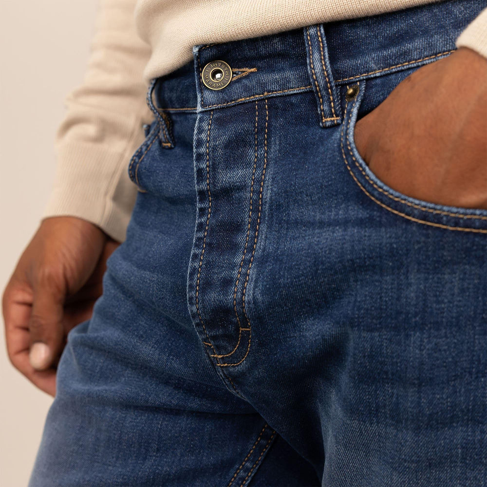 Man wearing Slim Leg Denim Jeans in Deep Navy, closeup. |navy wash denim