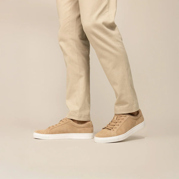 Man wearing Marame Smart Suede Trainers in Sandstone, front view.