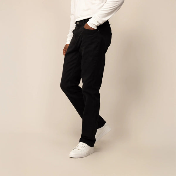 Man wearing Straight Leg Denim Jeans in Black, front view. |black denim