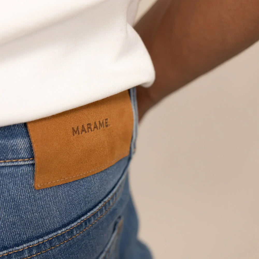 Man wearing Marame Straight Leg Denim Jeans in Classic Wash, closeup. |classic wash denim