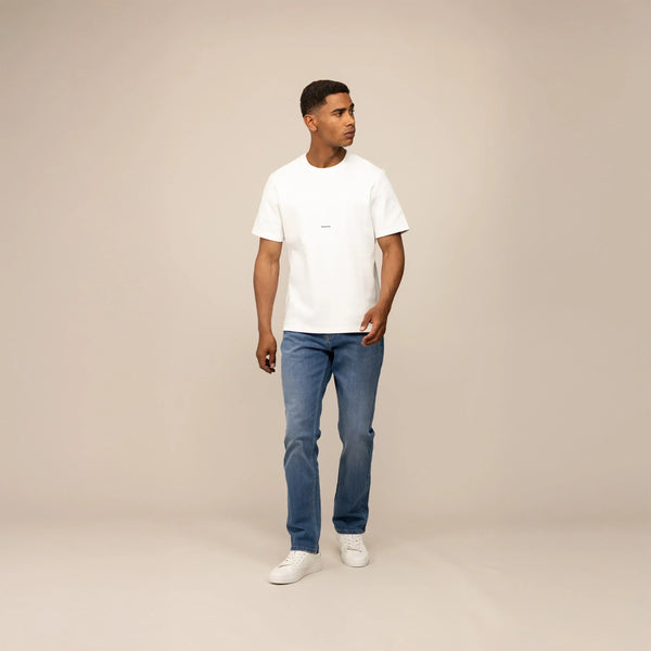 Man wearing Marame Straight Leg Denim Jeans in Classic Wash, front view.