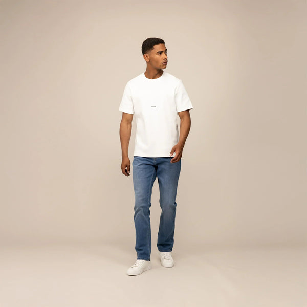 Man wearing Marame Straight Leg Denim Jeans in Classic Wash, front view. |classic wash denim
