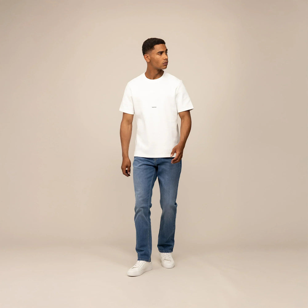 Man wearing Marame Straight Leg Denim Jeans in Classic Wash, front view. |classic wash denim