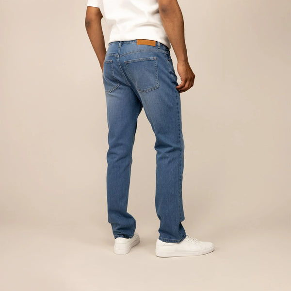 Man wearing Straight Leg Denim Jeans in Classic Wash, rear view.