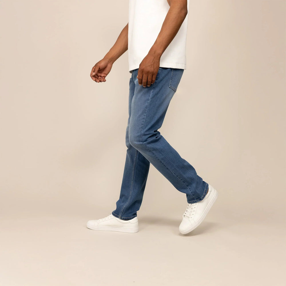 Man wearing Straight Leg Denim Jeans in Classic Wash, side view. |classic wash denim