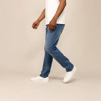 Man wearing Straight Leg Denim Jeans in Classic Wash, side view. |classic wash denim