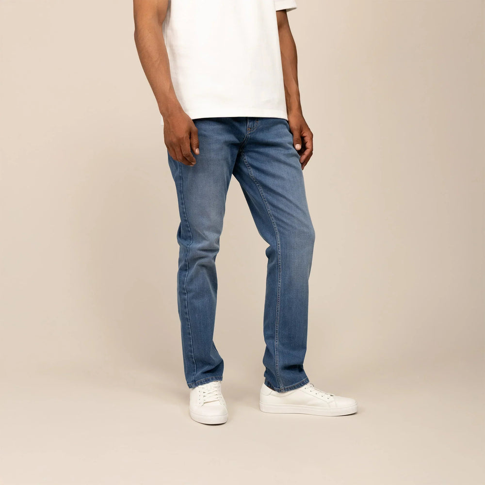 Man wearing Marame Straight Leg Denim Jeans in Classic Wash, front view. |classic wash denim